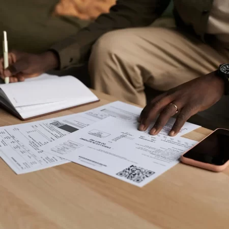 Black man doing taxes at home and filling out papers