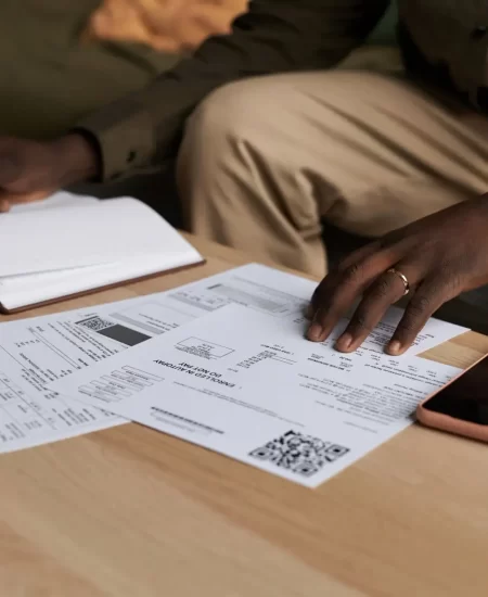 Black man doing taxes at home and filling out papers