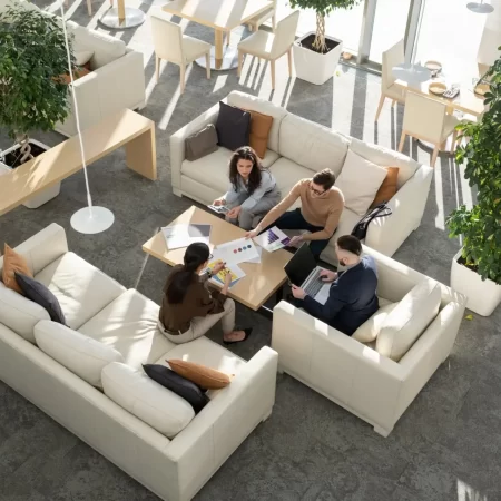 Group of young auditors of high tech corporation discussing documents